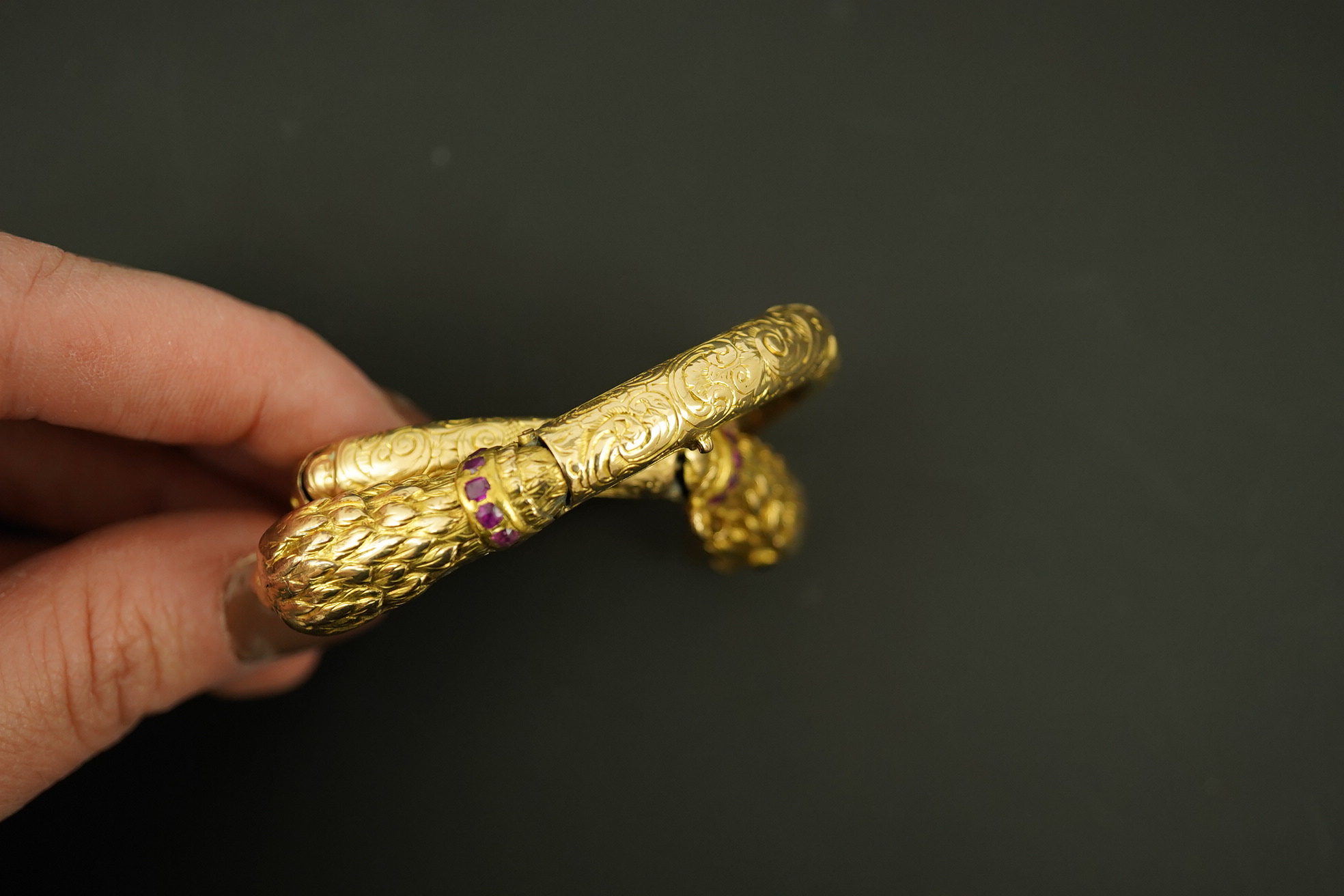 An antique Russian? engraved gold, garnet and ruby cluster set double headed eagle open hinged bracelet